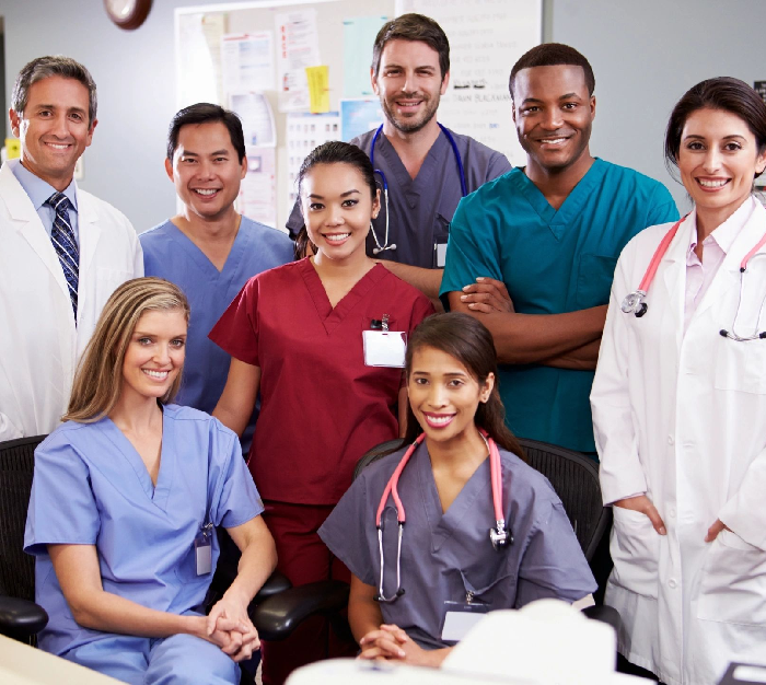 A group of doctors and nurses posing for the camera.